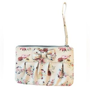 Cute flower wristlet with a bow on the front. Not sure the brand.